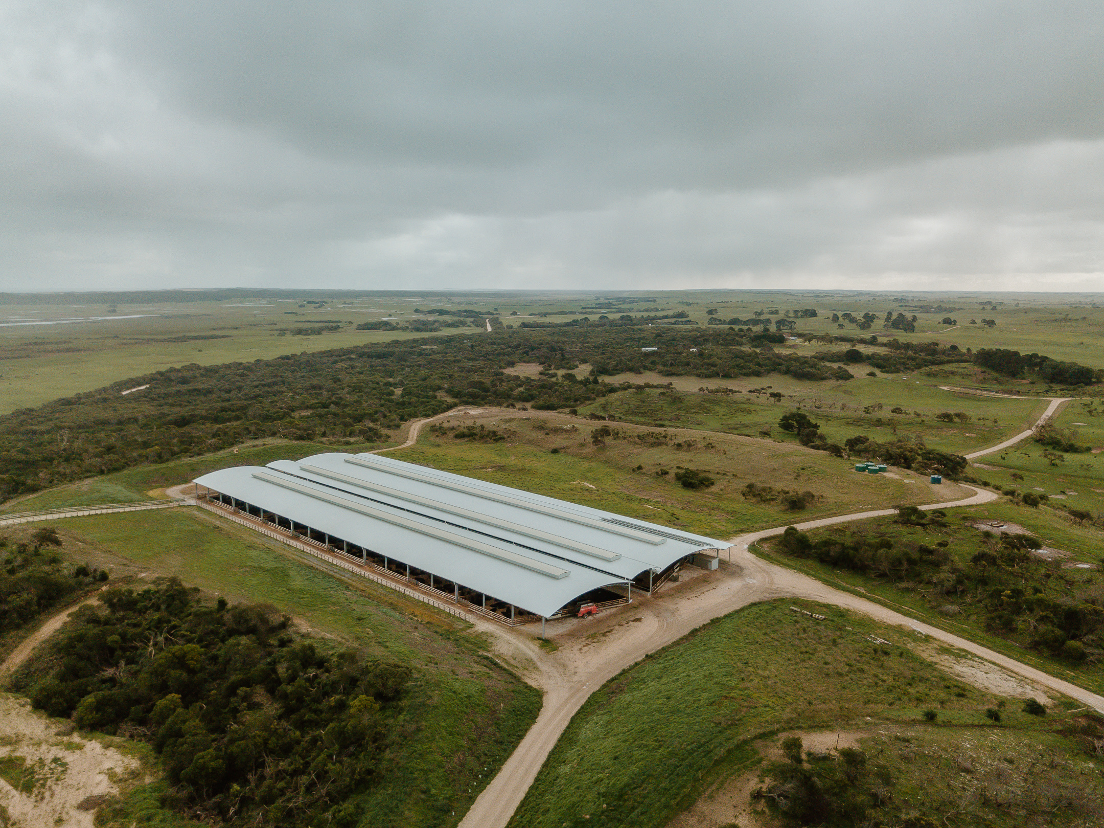Aerial view of the curved-roof feeding barns at Mayura Station in the Limestone Coast landscape