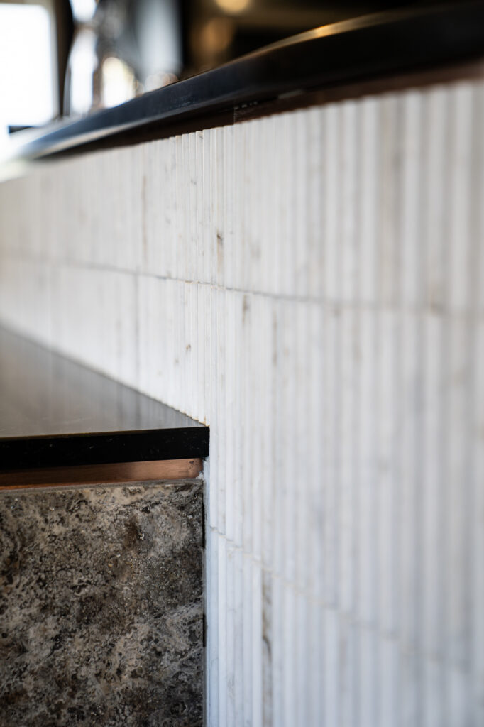Fluted marble bar with brass trim at the Mayura Wagyu Steakhouse