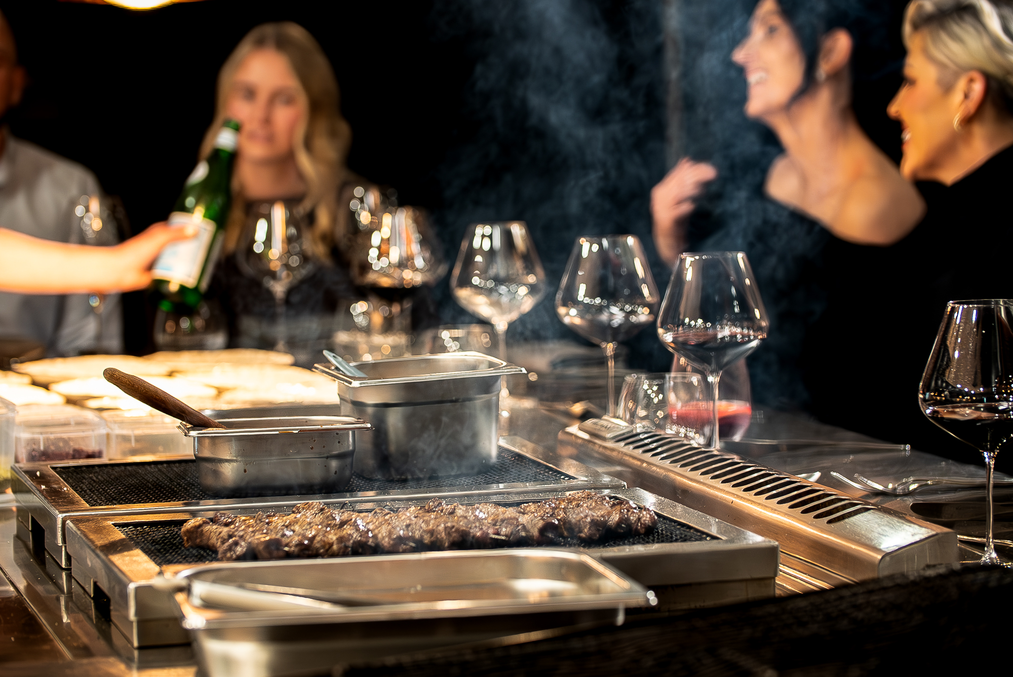 Head Chef searing Full-Blood Wagyu at the Chef's Table while guests watch at the Mayura Wagyu Steakhouse