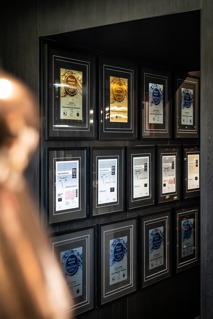 A wall of framed award certificates in the entrance of the restaurant.